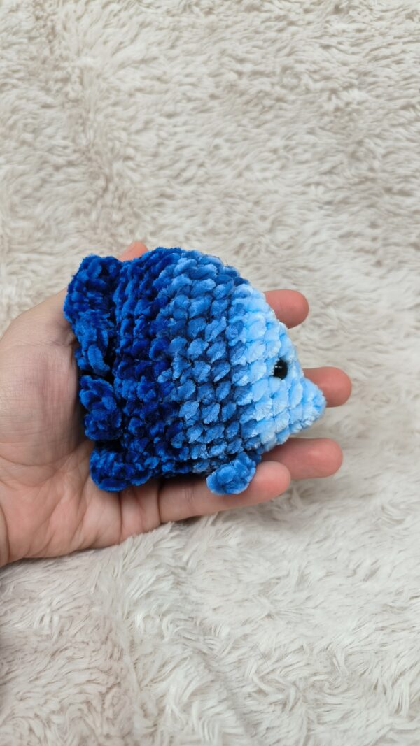 Amigurumi con forma de pez tejido en lana de terciopelo. Distintos tonos de azul